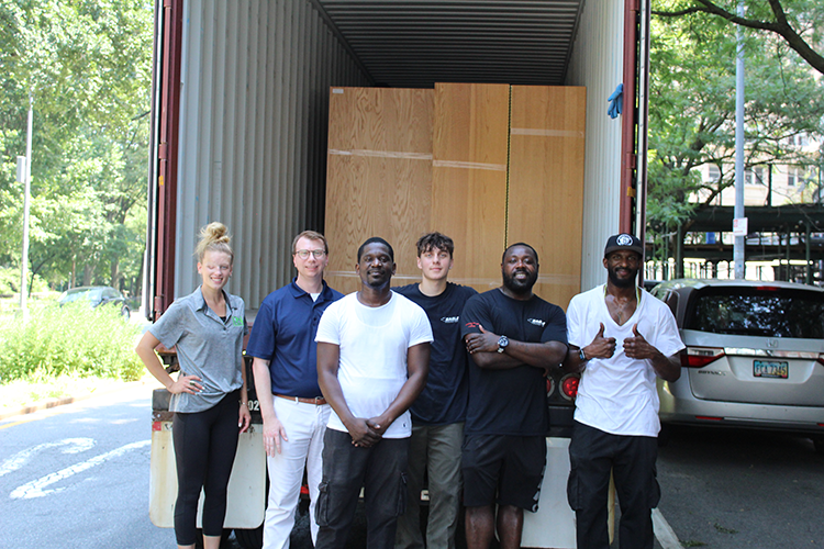 The IRN team and Justin Cottrell (second to the left) of Columbia Housing stand in front of a cargo truck full of items headed for Ukraine.