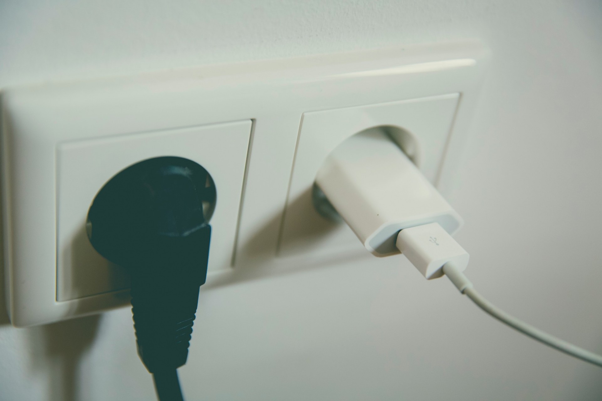 an electrical outlet with two plugs, black and white