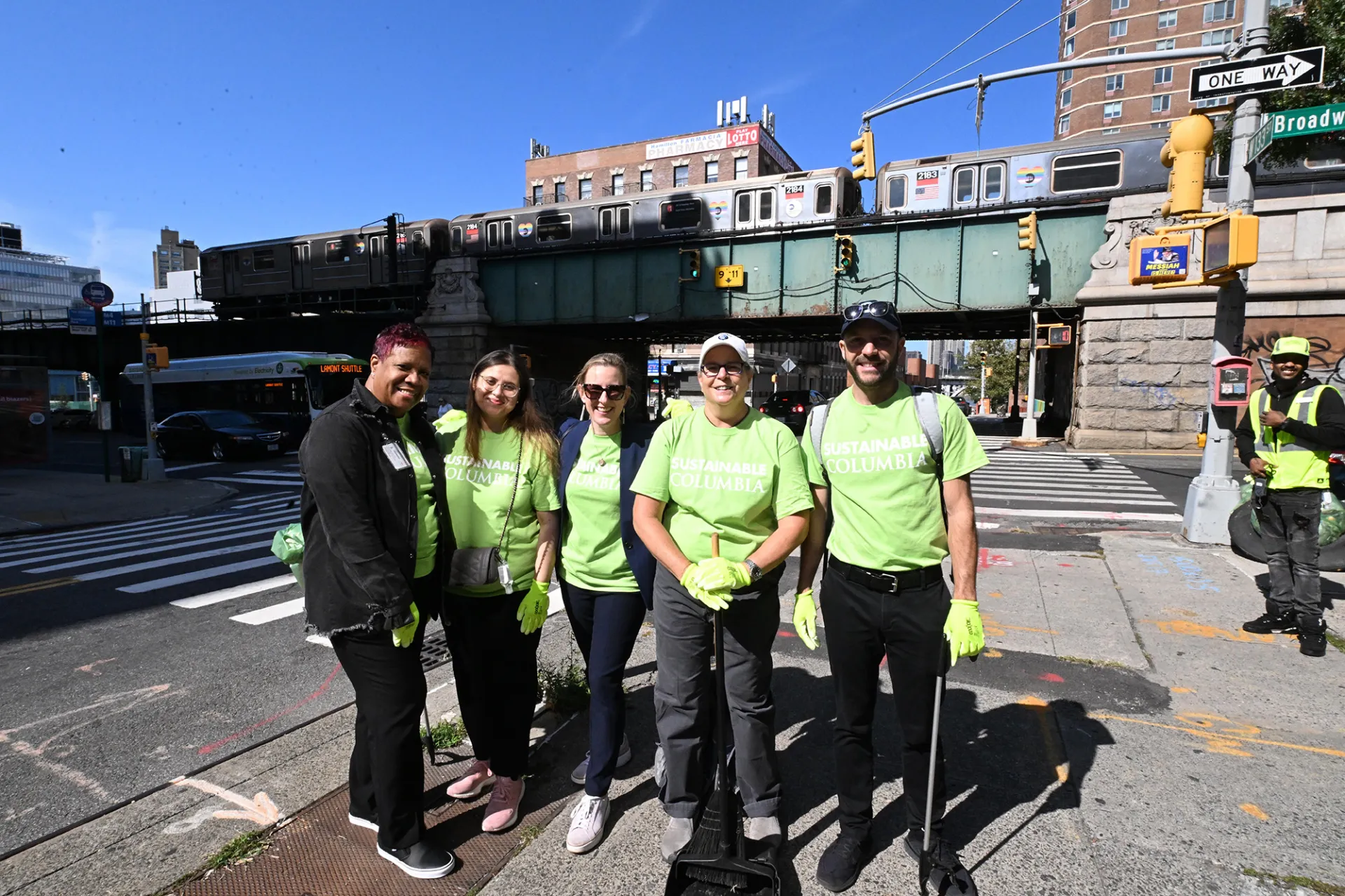 The Office of Sustainability members at the Broadway Sweep wearing green Sustainable Columbia t-shirts