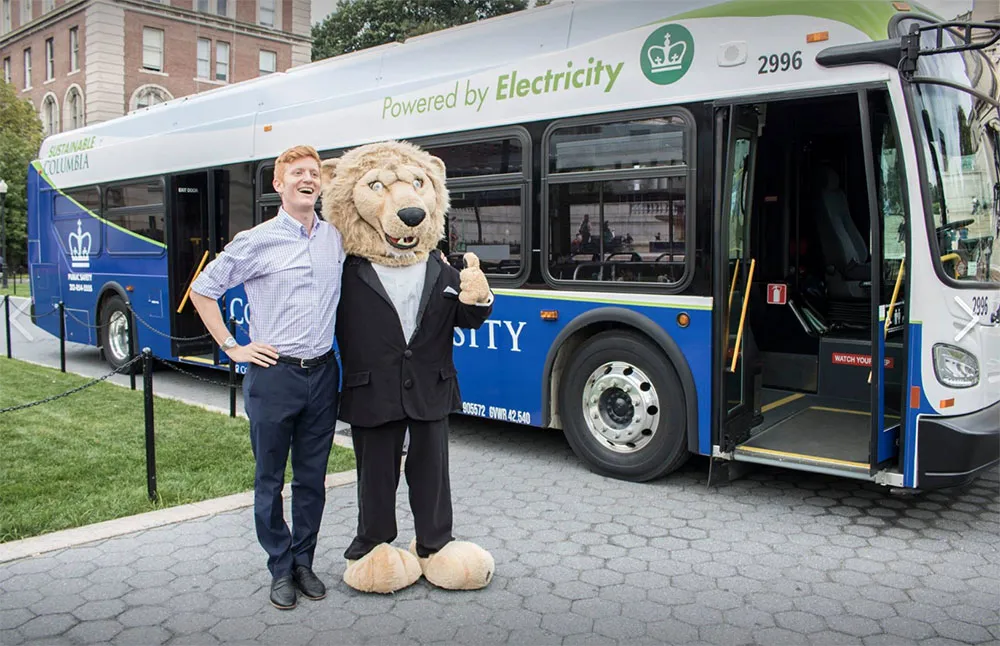 Student poses with Roar-ee