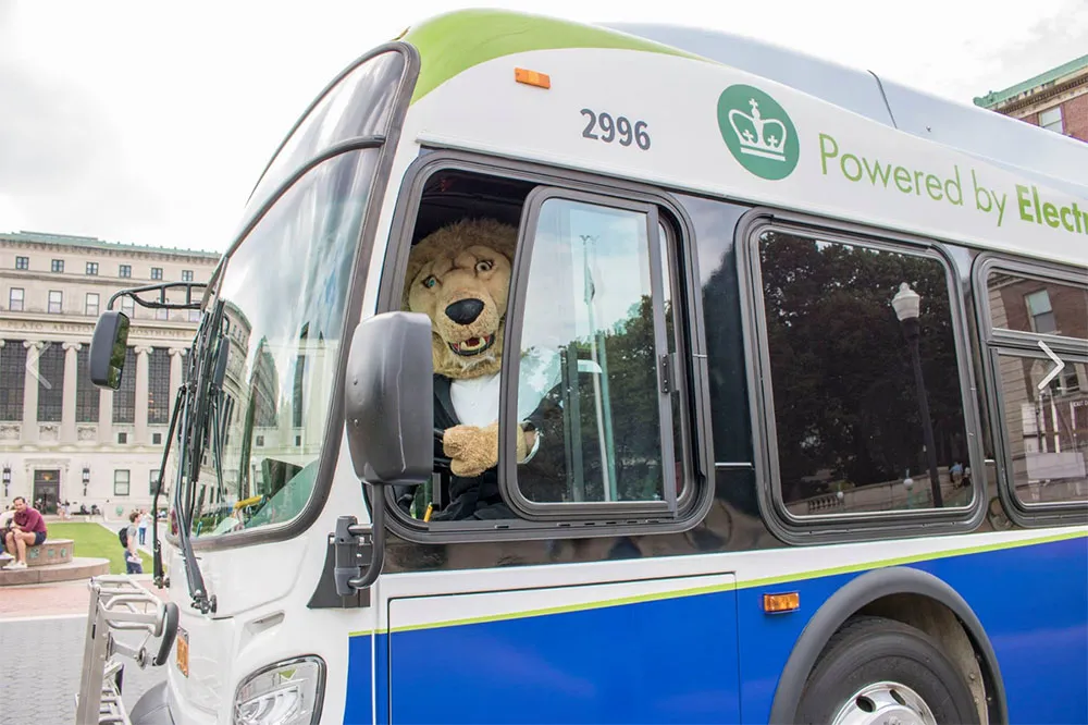 Roar-ee in driver's seat of electric bus