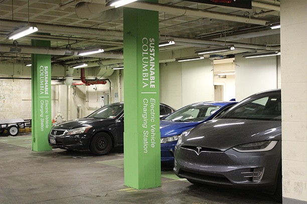 Parking garage with electric vehicles charging and Sustainable Columbia green branding