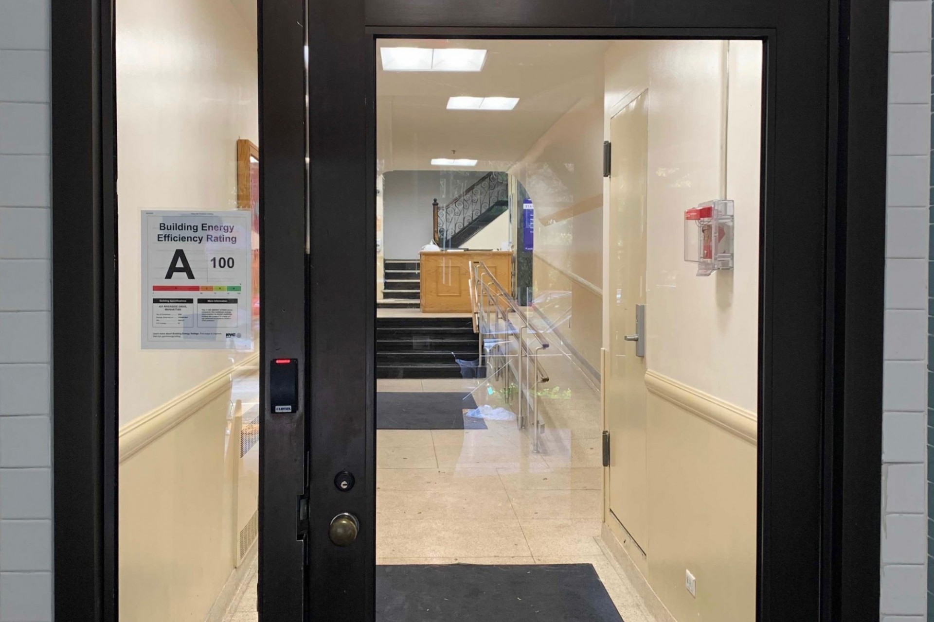 Woodbridge Hall is one of many Columbia buildings that received an A rating for energy efficiency. Glass doors of a residential building with a sign for energy efficiency rating, demonstrating an A.