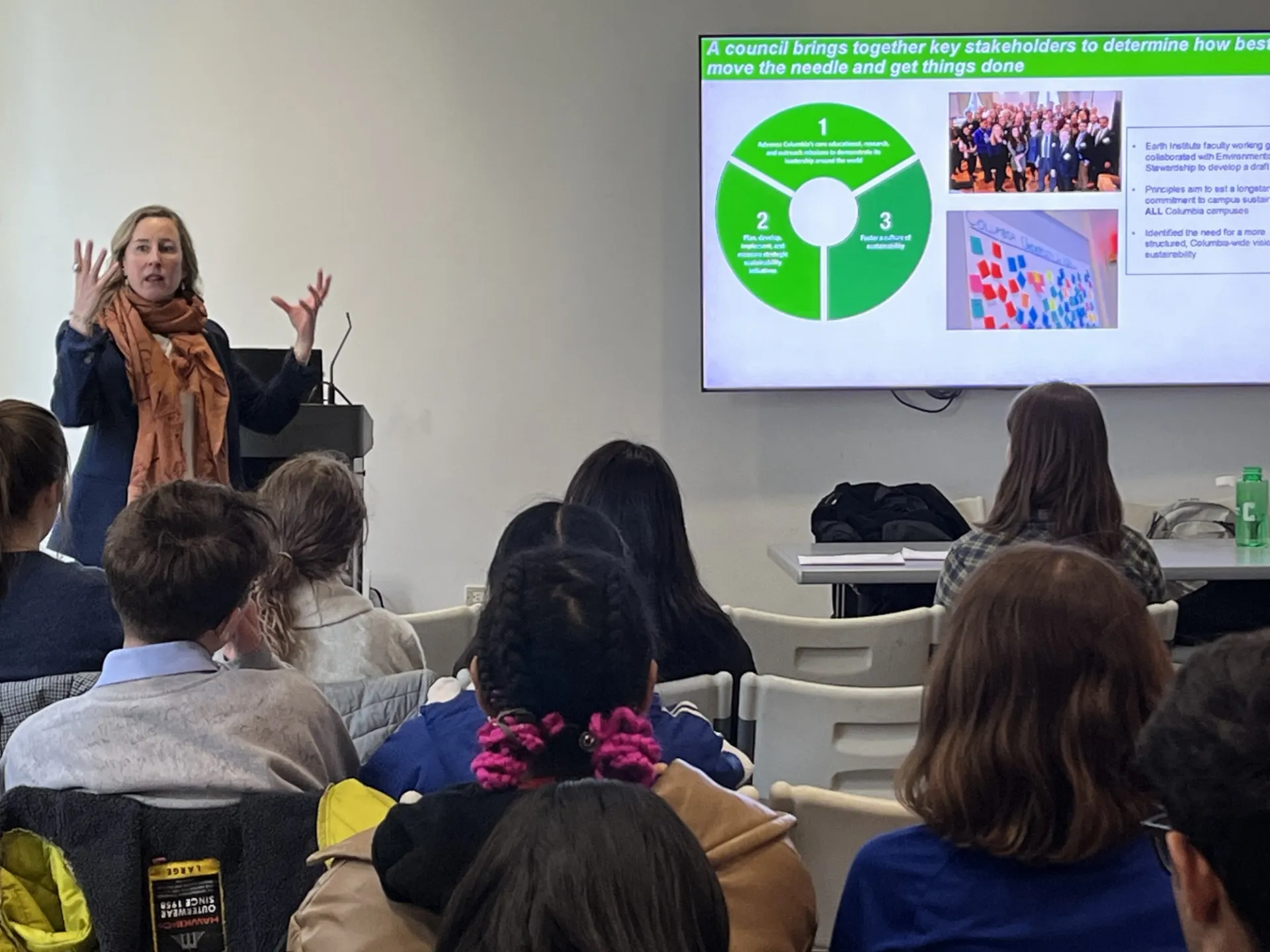Jessica Prata presents a powerpoint to student attendees