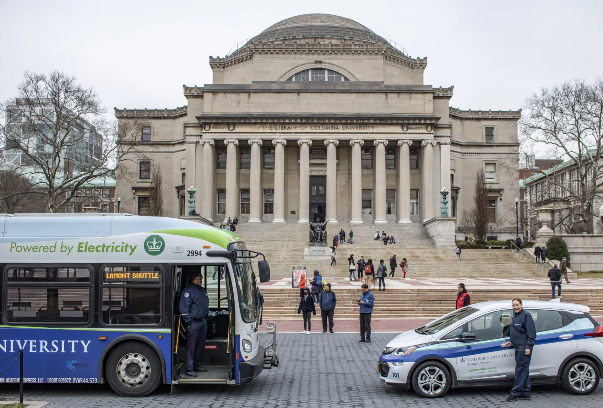 Shuttle bus and electric vehicle in front of Low Library