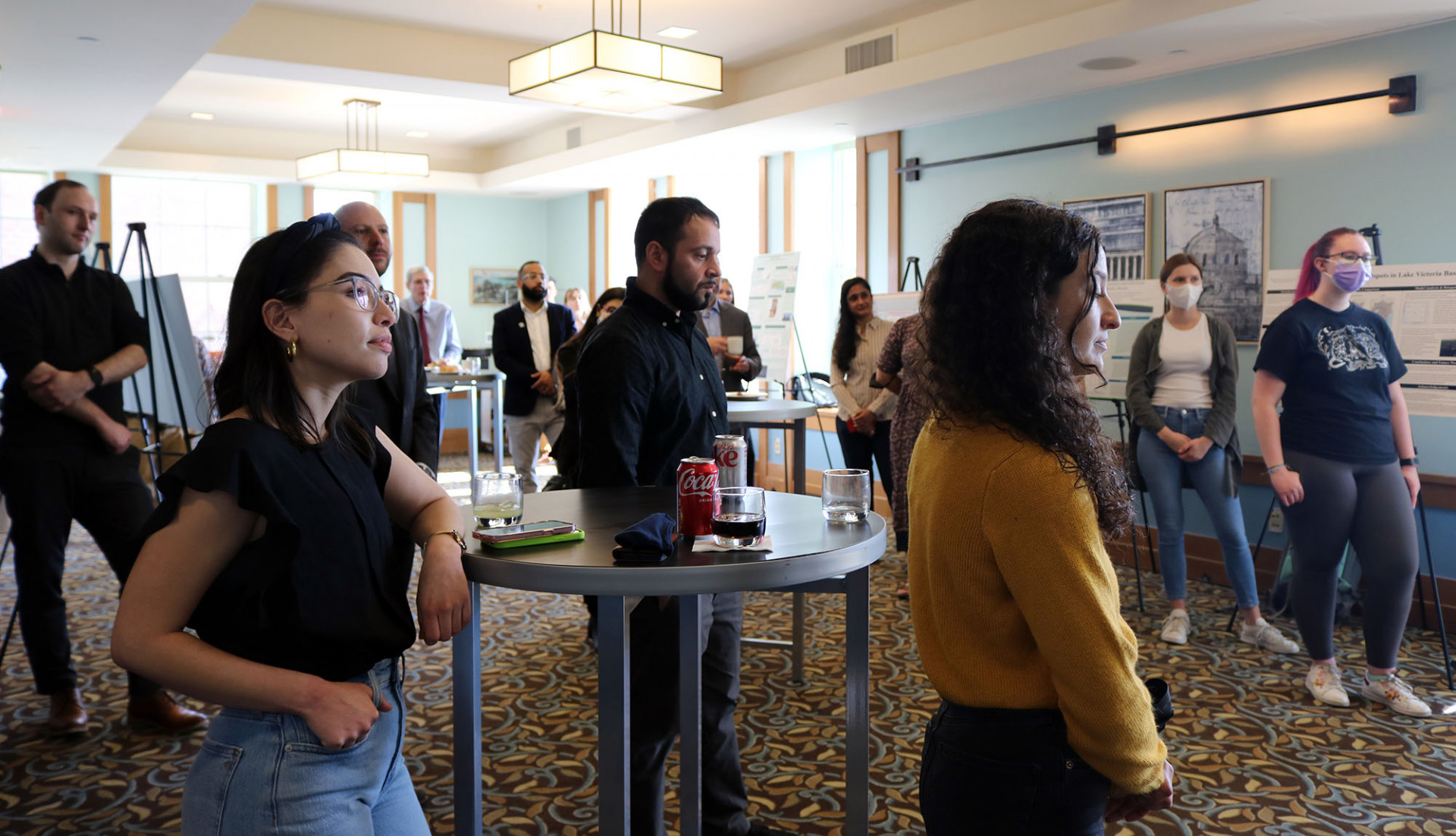 People standing listening to a speaker at an event at Faculty House