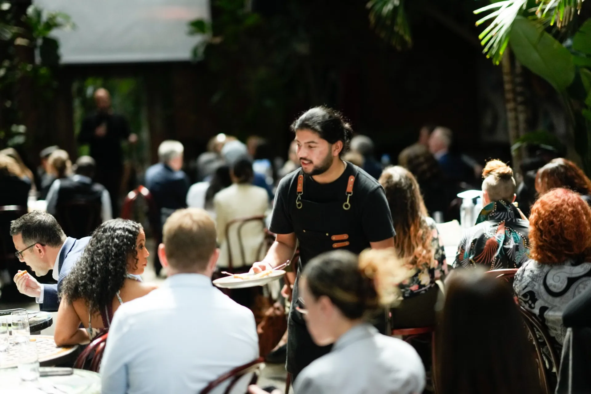 A waiter passes out plant-based appetizers