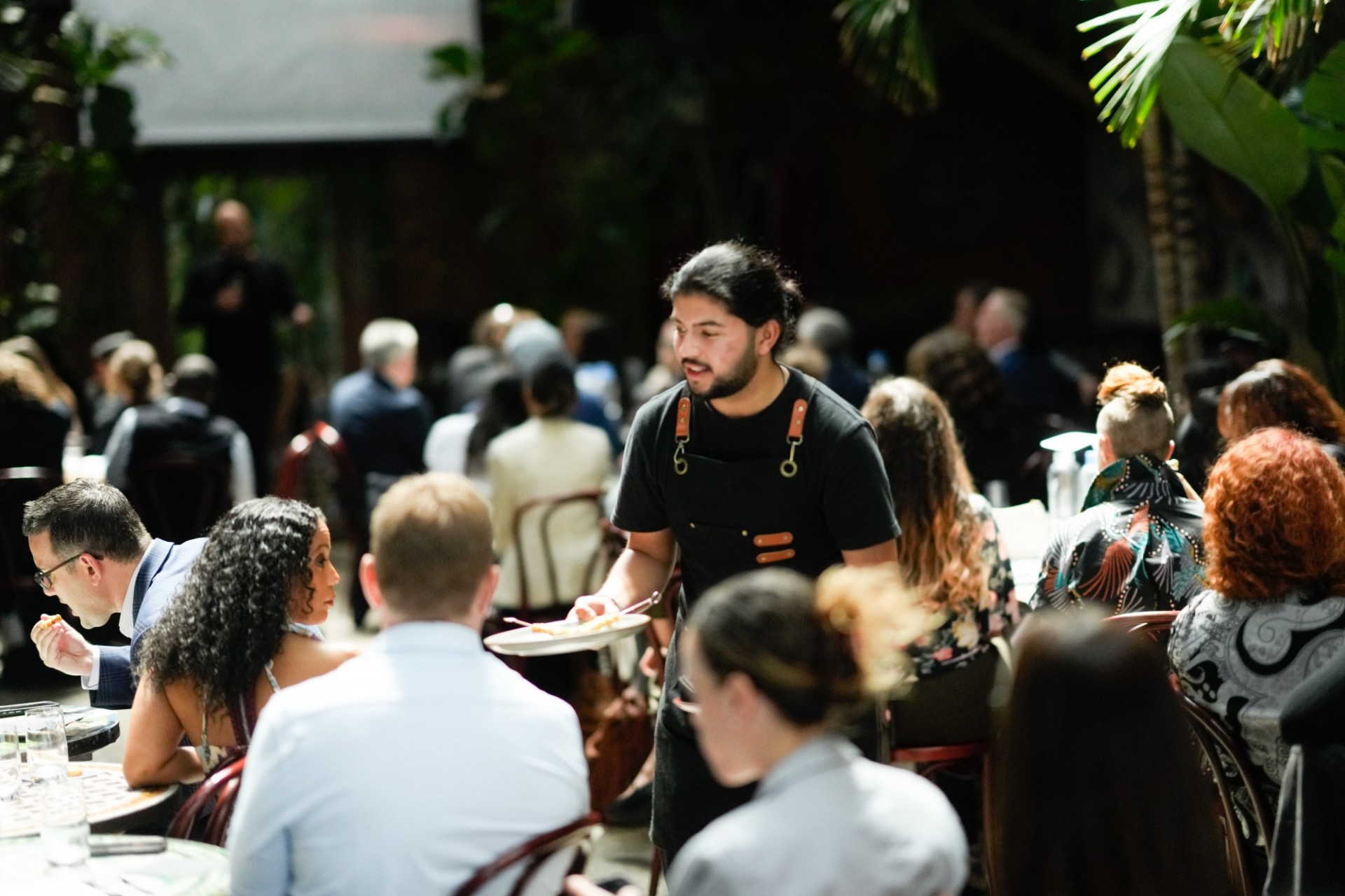 A waiter passes out plant-based appetizers