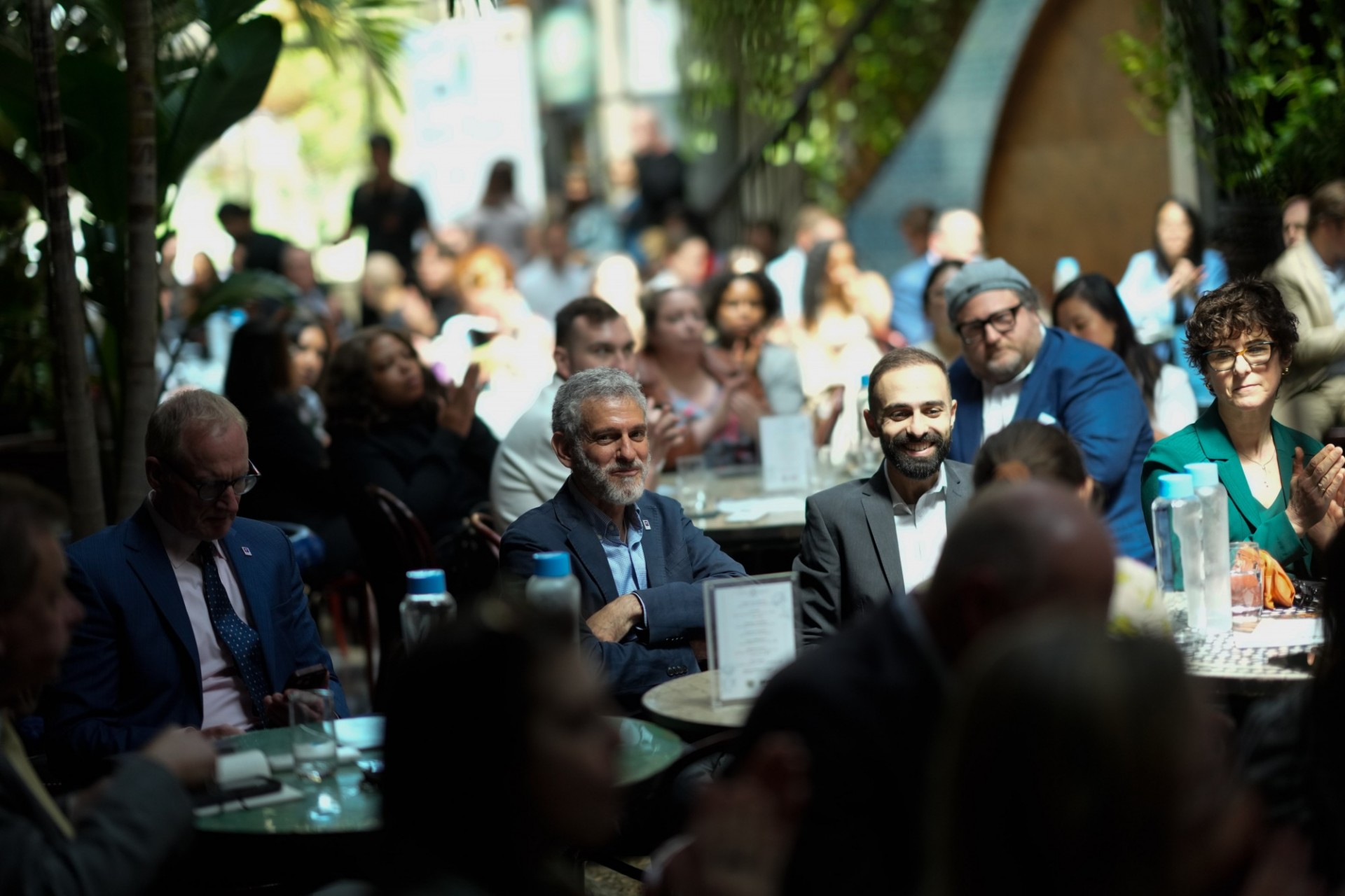 The audience listens to the speaker on stage
