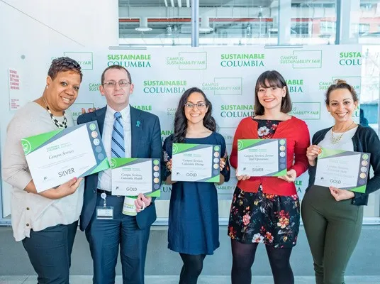 Campus Services leaders pose for a photo with their Sustainable Leaders Network certificates